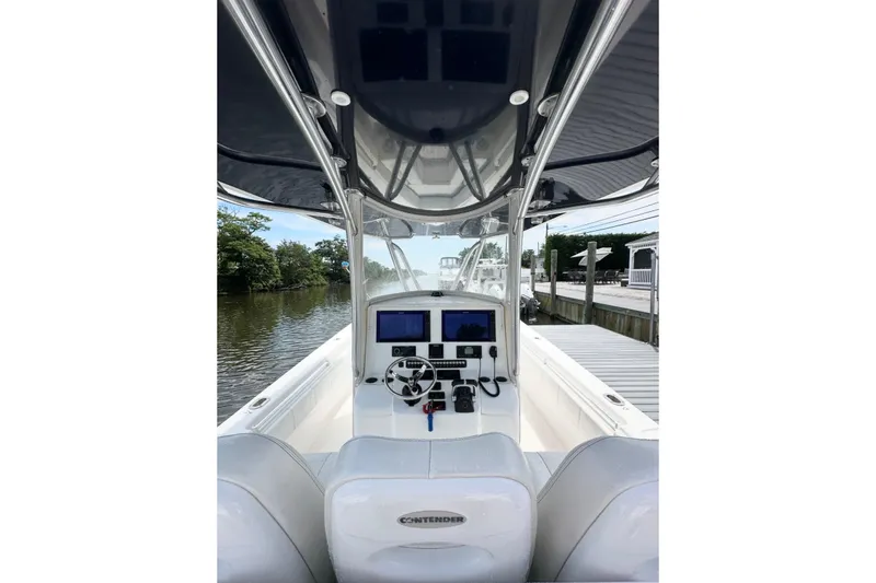 Slide: The Image of 2019 Contender 35 ST boat cockpit with modern navigation equipment and sleek design. - 11