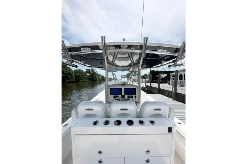 Slide: The Image of 2019 Contender 35 ST boat cockpit with helm, seats, and waterway view. - 12
