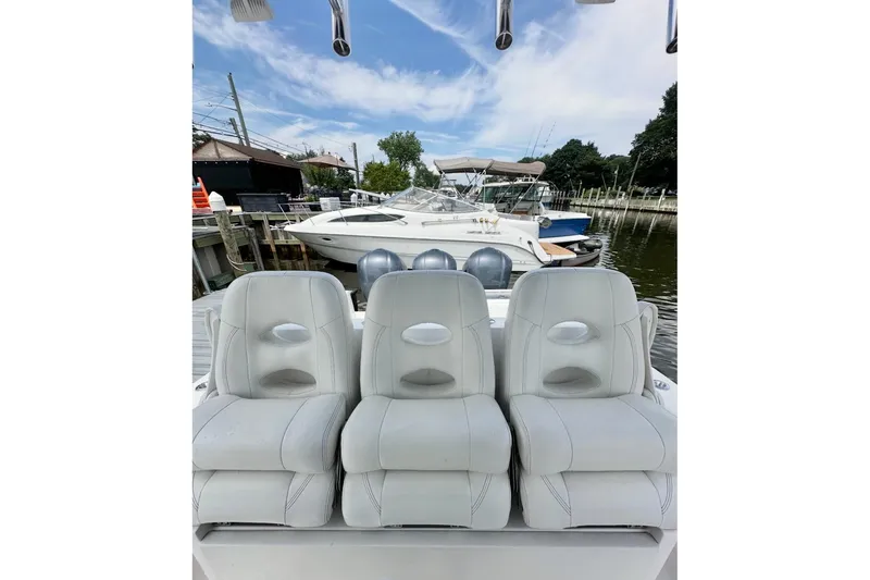 Slide: The Image of 2019 Contender 35 ST boat with white seating at a marina dock. - 14