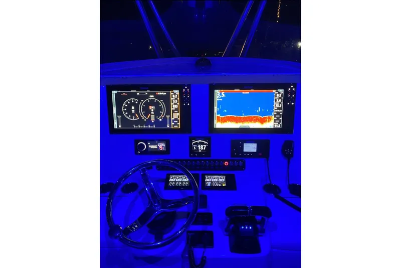 Slide: The Image of Cockpit of 2019 Contender 35 ST boat with illuminated navigation screens. - 20