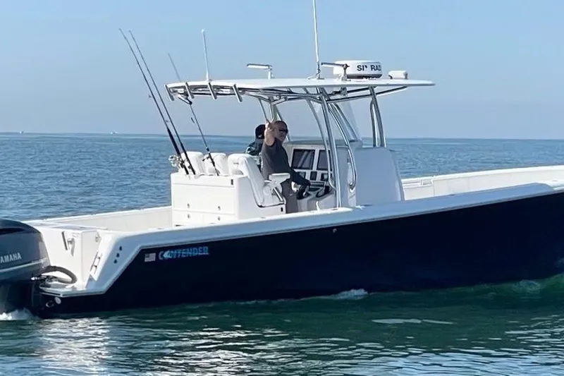Slide: The Image of 2019 Contender 35 ST boat cruising on open water with fishing rods. - 3