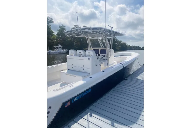 Slide: The Image of 2019 Contender 35 ST boat docked, featuring sleek design and spacious seating. - 4