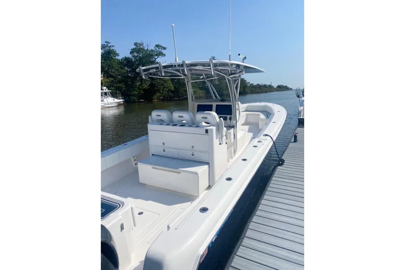 Slide: The Image of 2019 Contender 35 ST boat docked, featuring spacious seating and sleek design. - 5