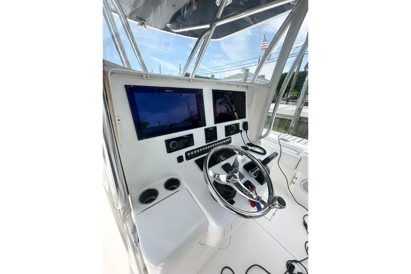 Slide: The Image of 2019 Contender 35 ST boat helm with dual screens and steering wheel. - 6