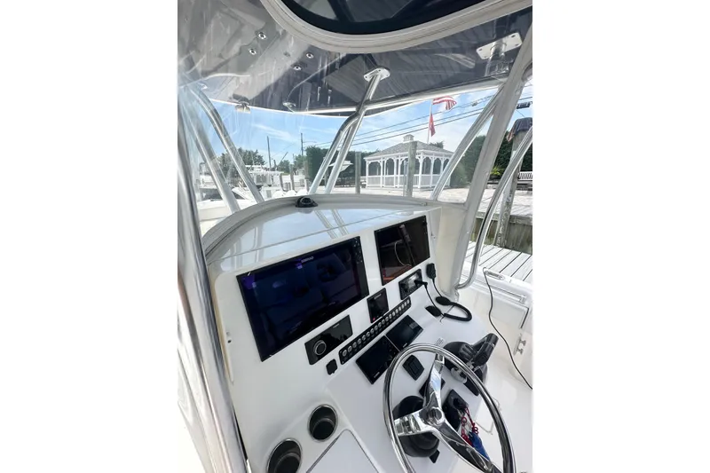 Slide: The Image of 2019 Contender 35 ST boat cockpit with modern navigation equipment and steering wheel. - 7
