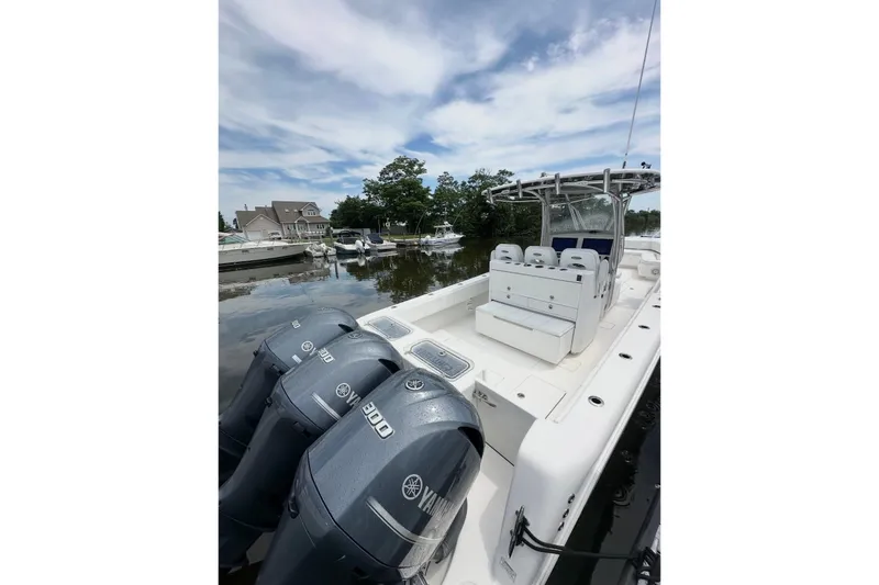 Slide: The Image of 2019 Contender 35 ST boat with triple Yamaha 300 engines docked at marina. - 9