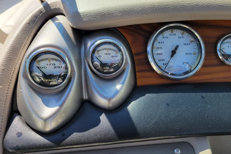 Slide: The Image of Dashboard gauges of a 2006 Cobalt 250 boat, showing temperature and oil levels. - 11