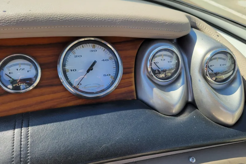 Slide: The Image of Dashboard gauges of a 2006 Cobalt 250 boat, featuring fuel, tachometer, volts, and trim indicators. - 12