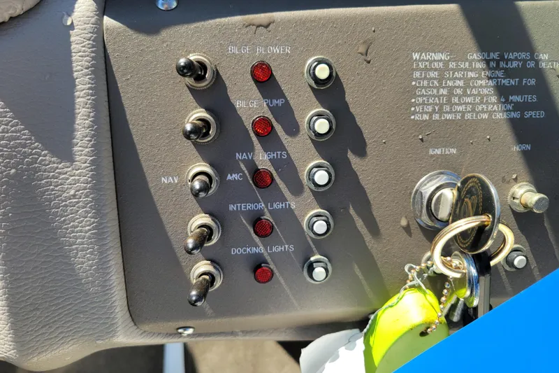 Slide: The Image of Control panel of a 2006 Cobalt 250 boat with switches and warning text. - 13
