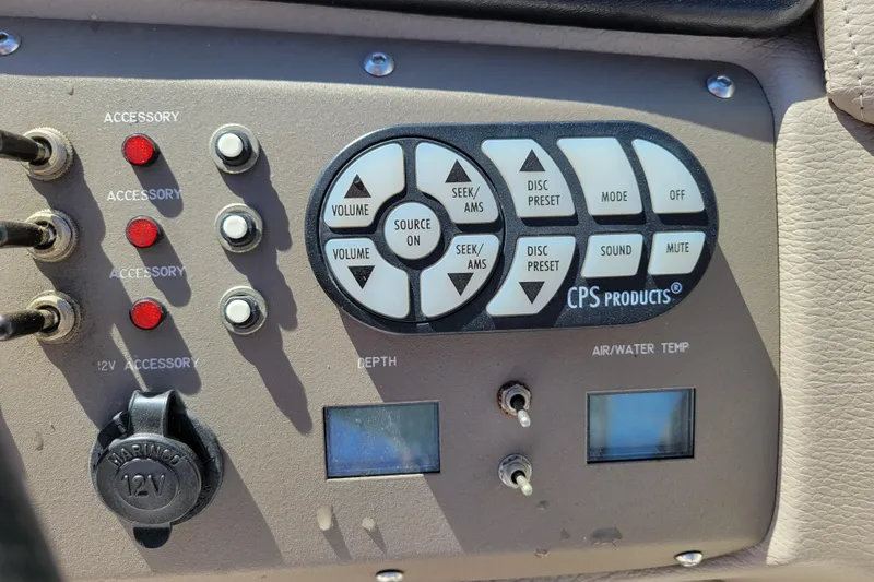 Slide: The Image of Control panel of a 2006 Cobalt 250 boat with accessory switches and audio controls. - 14