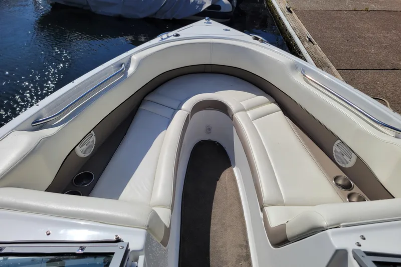 Slide: The Image of 2006 Cobalt 250 boat interior with white leather seating and cup holders. - 15