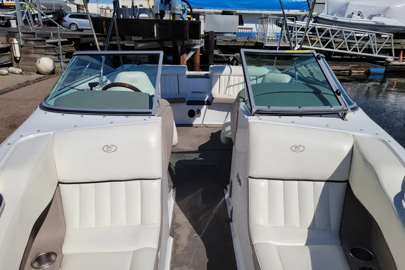 Slide: The Image of 2006 Cobalt 250 boat with white leather seating, docked at a marina. - 16
