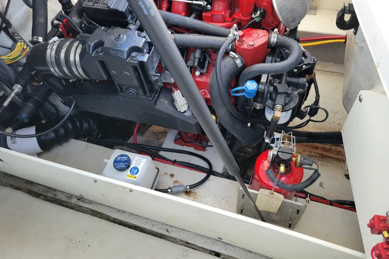 Slide: The Image of Engine compartment of a 2006 Cobalt 250 boat, showcasing mechanical components and wiring. - 20