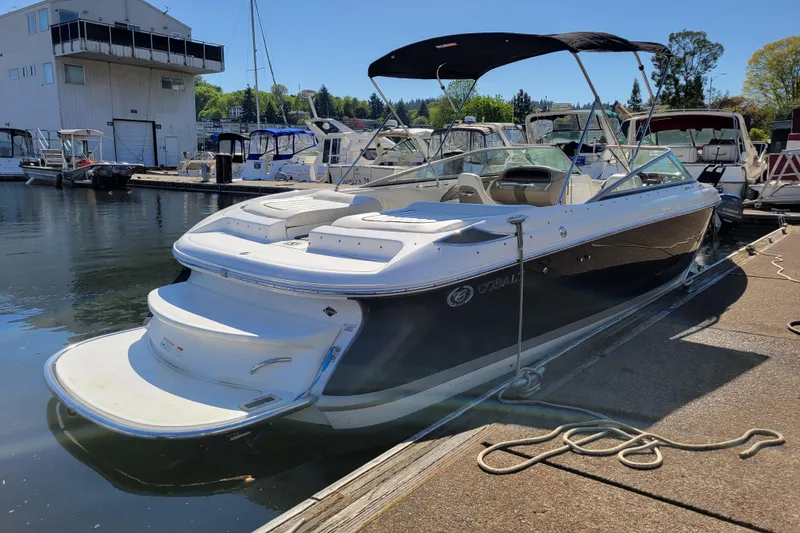 Slide: The Image of 2006 Cobalt 250 boat docked at a marina under clear blue skies. - 3