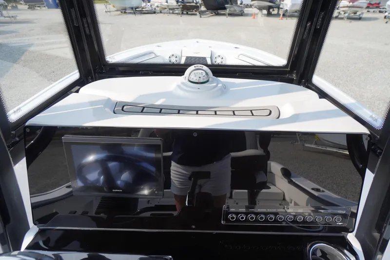 Slide: The Image of Helm of 2026 Tidewater 210 LXF boat with Garmin display and compass. - 18