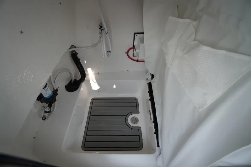 Slide: The Image of Interior view of 2026 Tidewater 210 LXF boat, featuring a clean, organized compartment. - 22