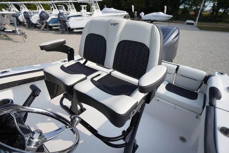 Slide: The Image of 2026 Tidewater 210 LXF boat interior with dual seats and steering wheel. - 27