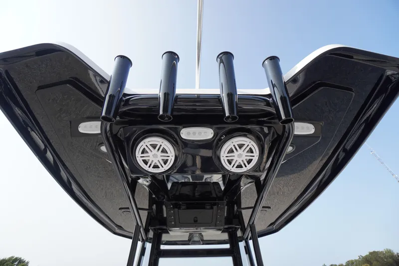 Slide: The Image of Tidewater 210 LXF 2026 boat T-top with rod holders and speakers, viewed from below. - 33