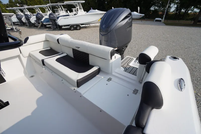 Slide: The Image of 2026 Tidewater 210 LXF boat interior with seating and outboard motor in a showroom. - 37