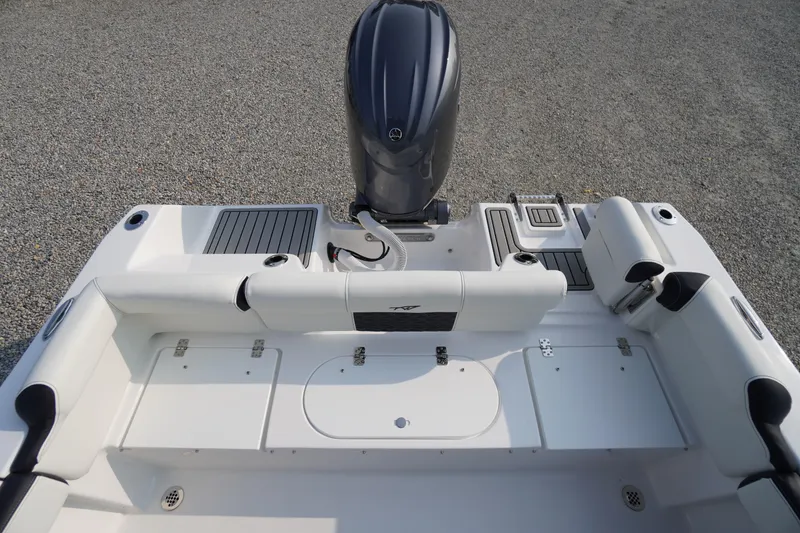 Slide: The Image of 2026 Tidewater 210 LXF boat interior with engine, seating, and storage compartments. - 38