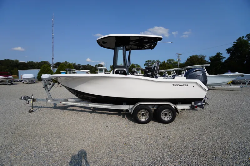 Slide: The Image of 2026 Tidewater 210 LXF boat on trailer, parked outdoors under clear blue sky. - 57