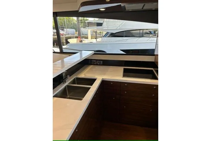 Slide: The Image of Modern kitchen interior on 2025 Maritimo M75 yacht with sleek countertops and sink and Miele Appliances - 10