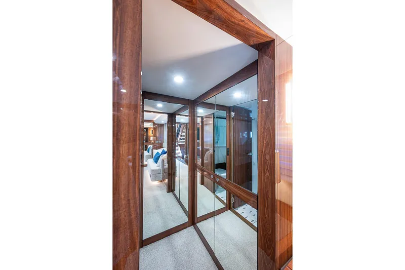 Slide: The Image of Luxurious interior hallway of 2025 Maritimo M75 yacht with wood paneling and mirrors. - 107