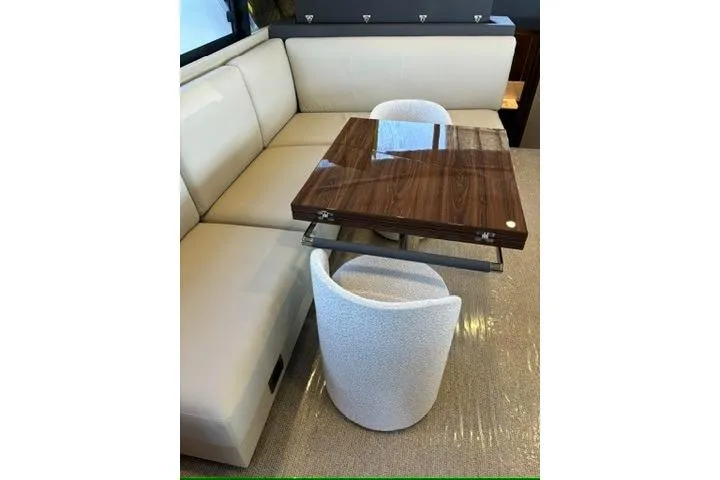 Slide: The Image of Luxurious interior of 2025 Maritimo M75 yacht with elegant seating and wooden high gloss walnut dining table - 11