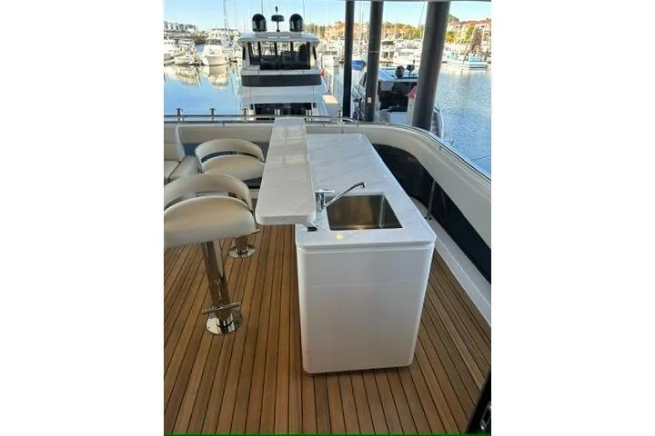 Slide: The Image of 2025 Maritimo M75 flybridge balcony with bar including icemaker, fridge and sink - 26