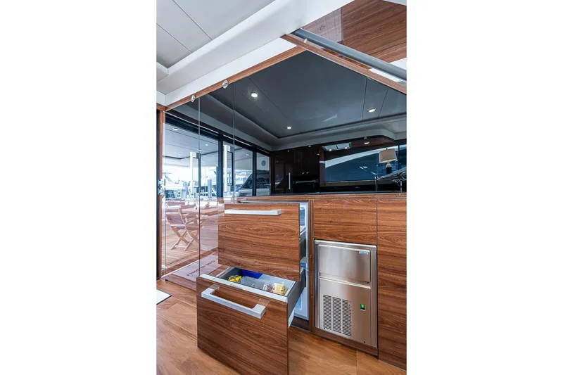 Slide: The Image of Luxurious interior of 2025 Maritimo M75 yacht with modern wooden cabinetry and sleek appliances. - 34