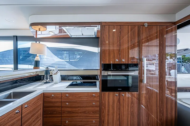 Slide: The Image of Luxurious kitchen interior of 2025 Maritimo M75 yacht with modern appliances and wood finish. - 36