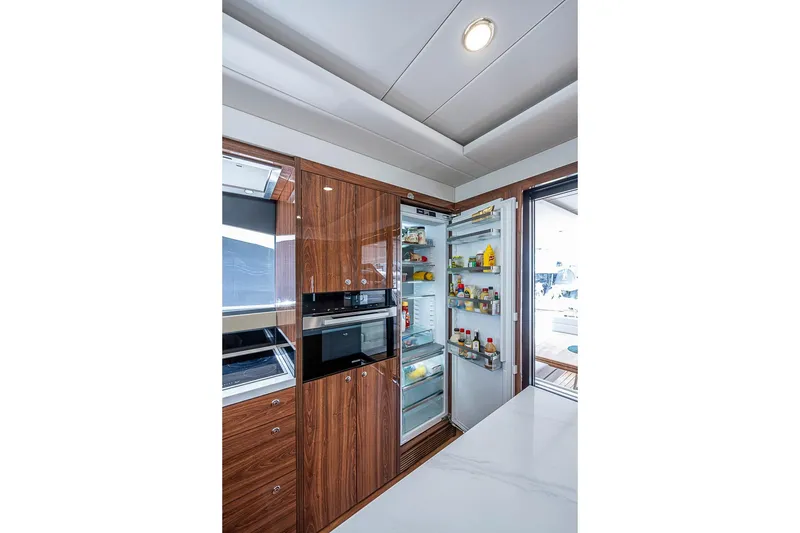 Slide: The Image of Luxurious kitchen interior of 2025 Maritimo M75 yacht with open fridge and modern appliances. - 37
