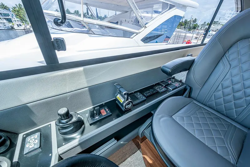 Slide: The Image of Interior view of 2025 Maritimo M75 yacht cockpit with control panel and luxurious seating. - 64