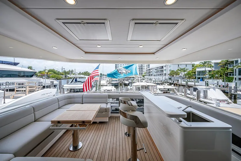 Slide: The Image of Luxurious 2025 Maritimo M75 yacht deck with seating, bar, and marina view. - 65