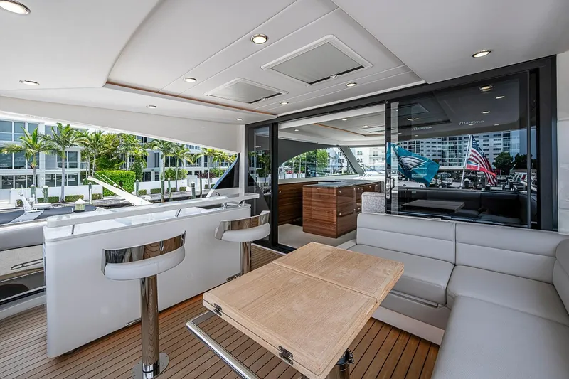 Slide: The Image of Luxurious 2025 Maritimo M75 yacht interior with modern seating and bar area. - 69