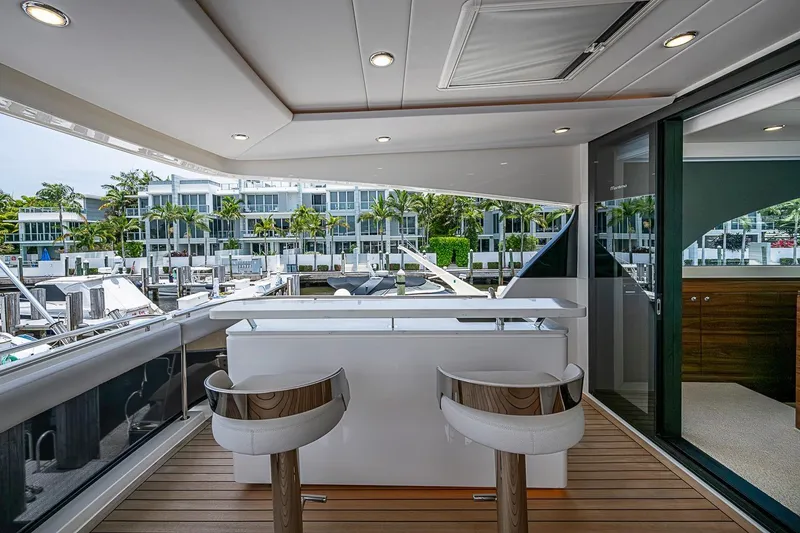 Slide: The Image of Luxurious 2025 Maritimo M75 yacht deck with modern seating and marina view. - 70