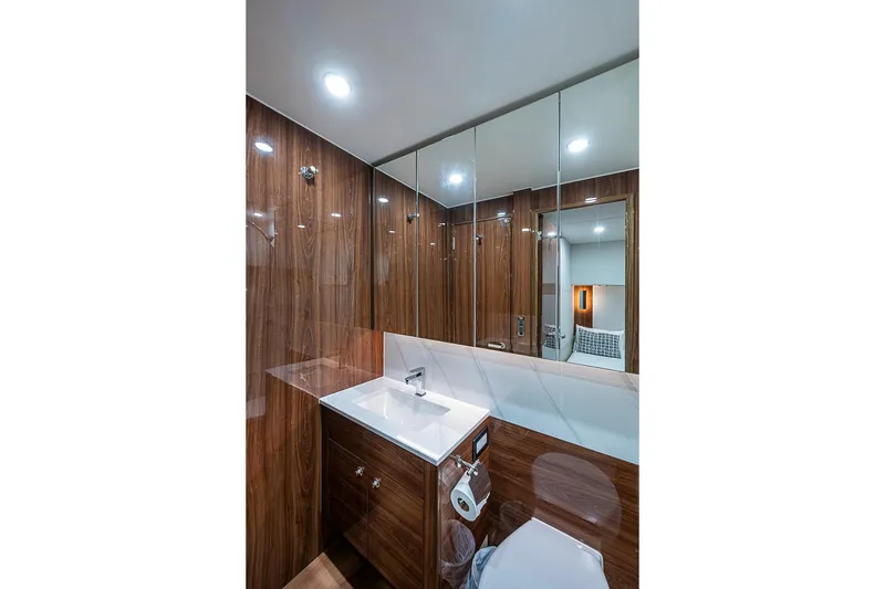 Slide: The Image of Luxurious bathroom interior of 2025 Maritimo M75 yacht with wood paneling and modern fixtures. - 73