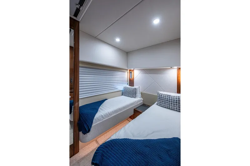 Slide: The Image of Luxurious cabin interior of 2025 Maritimo M75 yacht with twin beds and modern decor. - 77