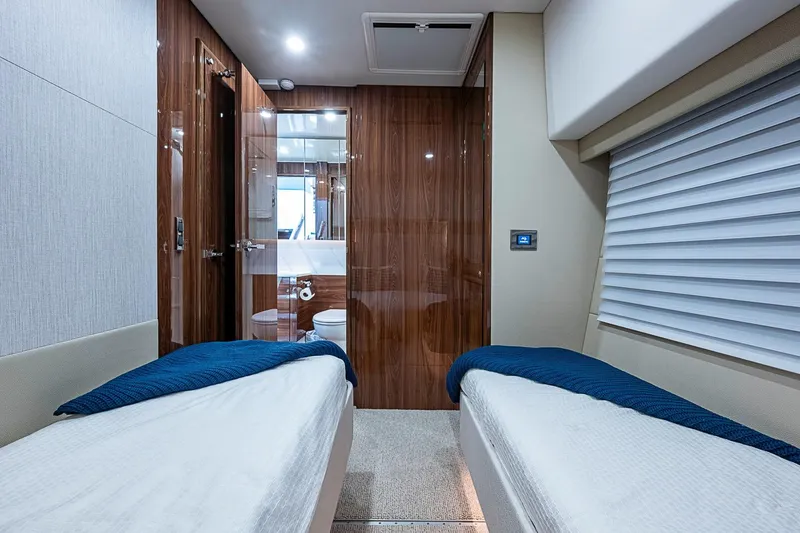 Slide: The Image of Luxurious 2025 Maritimo M75 yacht cabin with twin beds and modern bathroom. - 80
