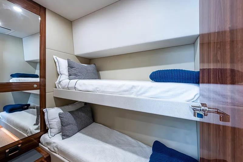 Slide: The Image of Luxurious 2025 Maritimo M75 yacht cabin with modern bunk beds and elegant decor. - 83