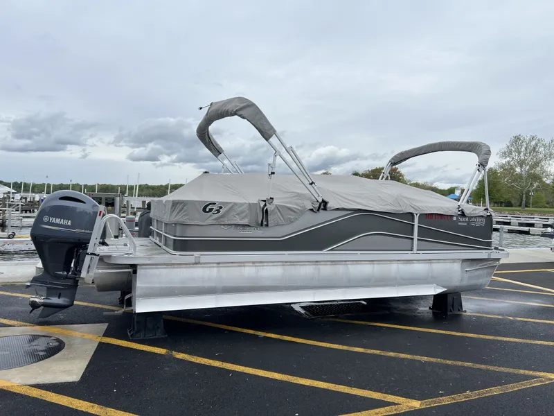 Slide: The Image of 2018 G3 V322 SS pontoon boat with Yamaha motor, covered on parking lot. - 8