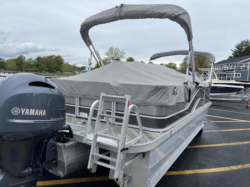 Slide: The Image of 2018 G3 V322 SS pontoon boat with Yamaha engine, covered on parking lot. - 9