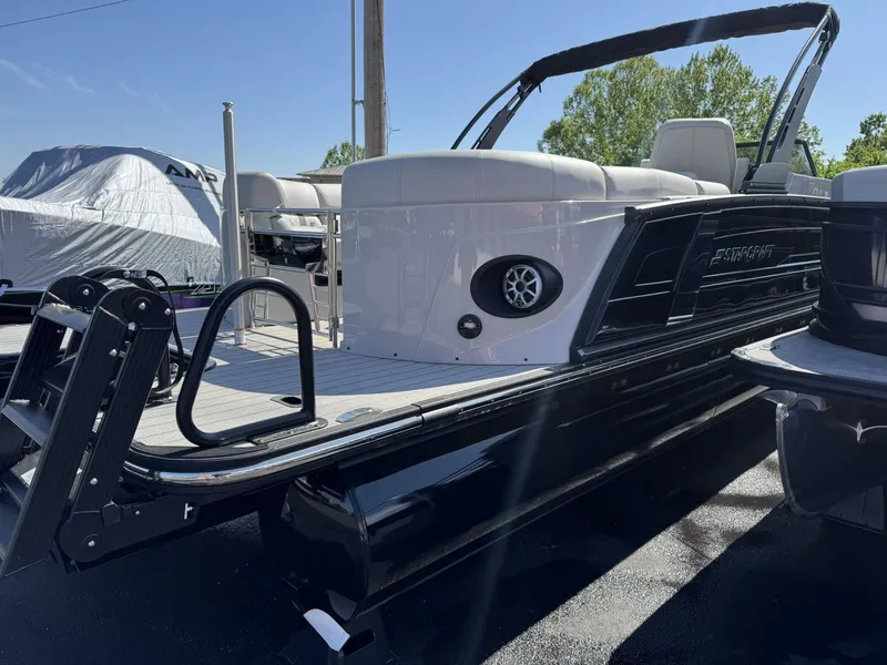 Slide: The Image of 2026 Starcraft RX 25 R DH pontoon boat in a parking lot. - 8