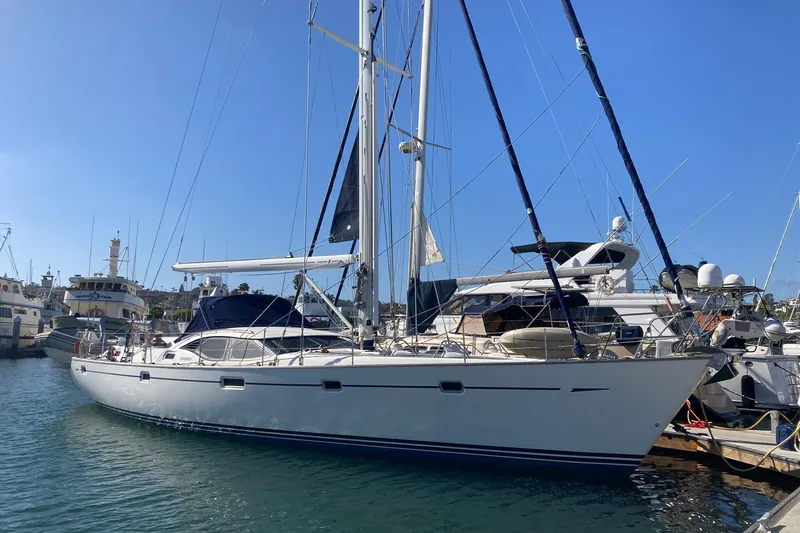 The Image of 2008 Oyster 56 Deck Saloon yacht docked in a marina under clear blue skies. - 0