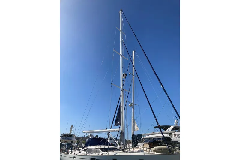 Slide: The Image of 2008 Oyster 56 Deck Saloon sailboat with tall mast against clear blue sky. - 2