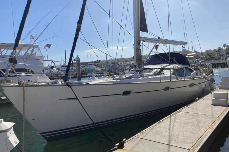 Slide: The Image of 2008 Oyster 56 Deck Saloon yacht docked at a marina under clear skies. - 5