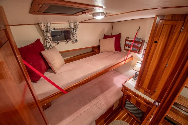 Slide: The Image of Cozy cabin interior of 2000 Duffy 42 boat with wooden furnishings and bunk beds. - 10