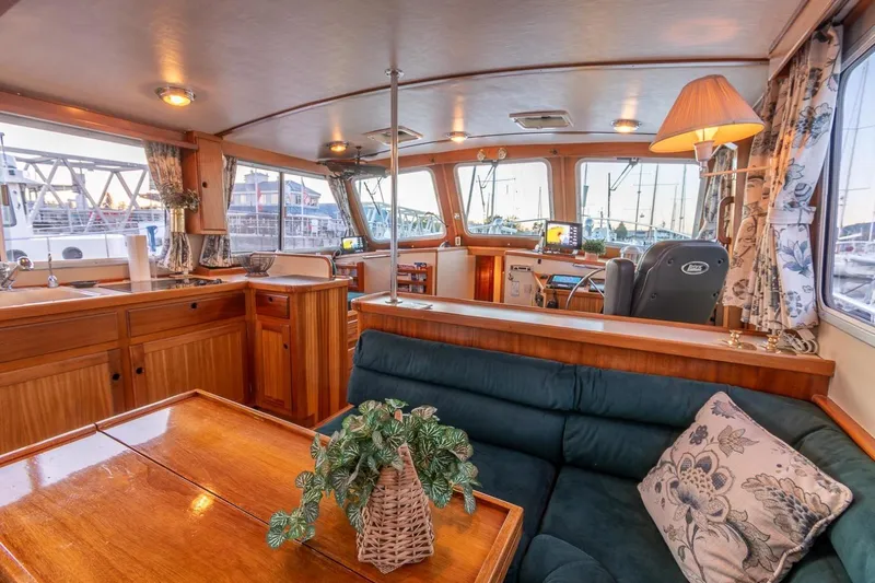 Slide: The Image of Interior of a 2000 Duffy 42 boat with wooden furnishings and cozy seating area. - 16