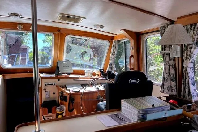 Slide: The Image of Interior of a 2000 Duffy 42 boat with steering wheel and navigation equipment. - 19