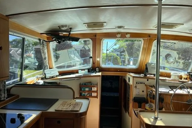 Slide: The Image of Interior of a 2000 Duffy 42 boat, featuring a well-equipped helm and panoramic windows. - 20
